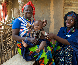 Healthy baby with her mother after benefiting from Action Against Hunger programme in Mali