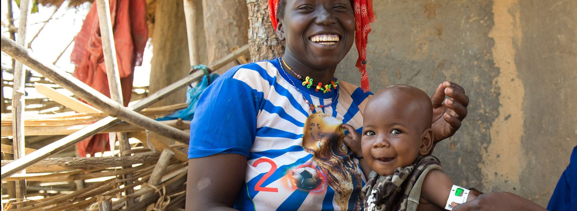 Healthy baby with her mother after benefiting from Action Against Hunger programme in Mali