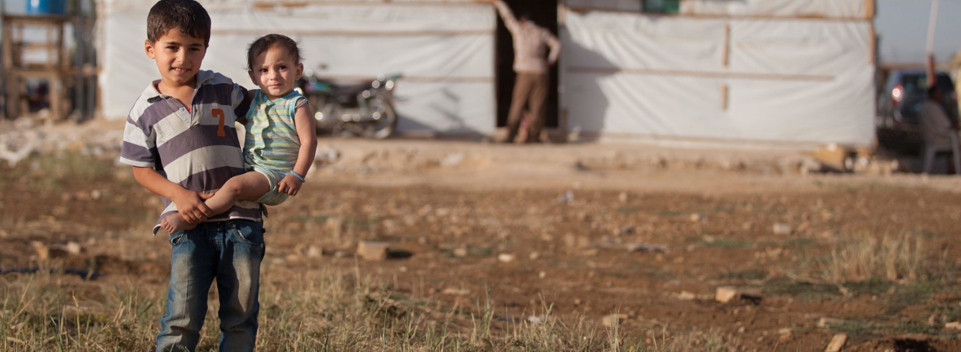 Refugee children standing in a camp