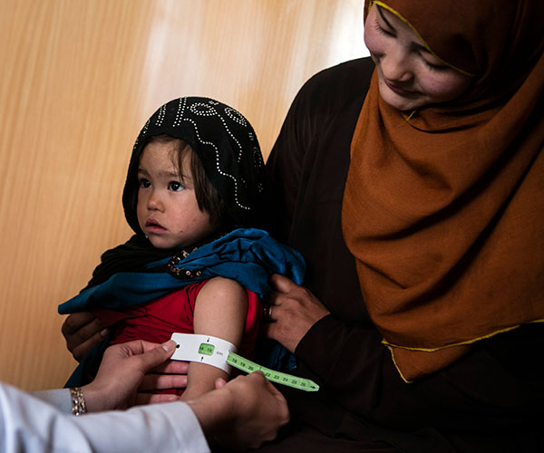 A girl being screened for malnutrition at an Action Against Hunger project in Afghanistan.