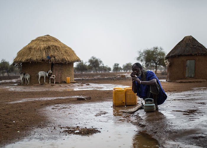Mamadou prays as the first rains of the year arrive in Mauritania.