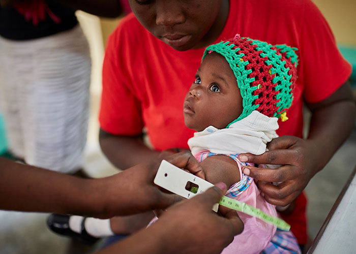 A child is screened for malnutrition at an Action Against Hunger treatment centre in Haiti.