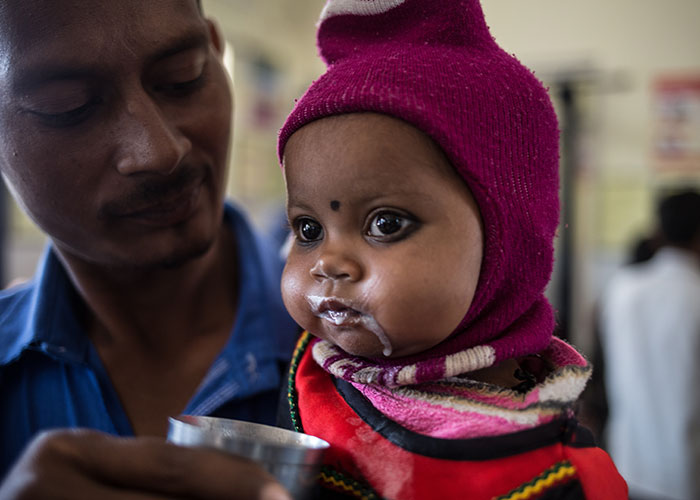 Bhumika receives treatment at an Action Against Hunger health centre in India.