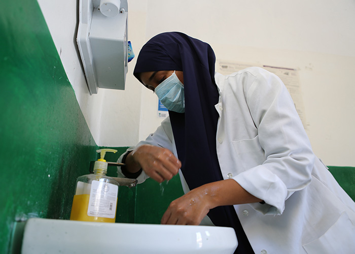 A nurse washes her hands at the Waabari Health Centre run by Action Against Hunger in Somalia.