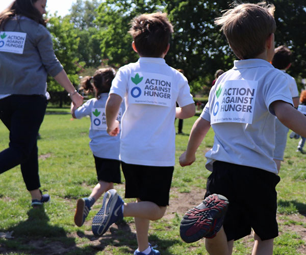 Children running a race at their school for Action Against Hunger