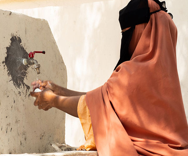 A woman washes her hands at an Action Against Hunger health centre in Somalia.