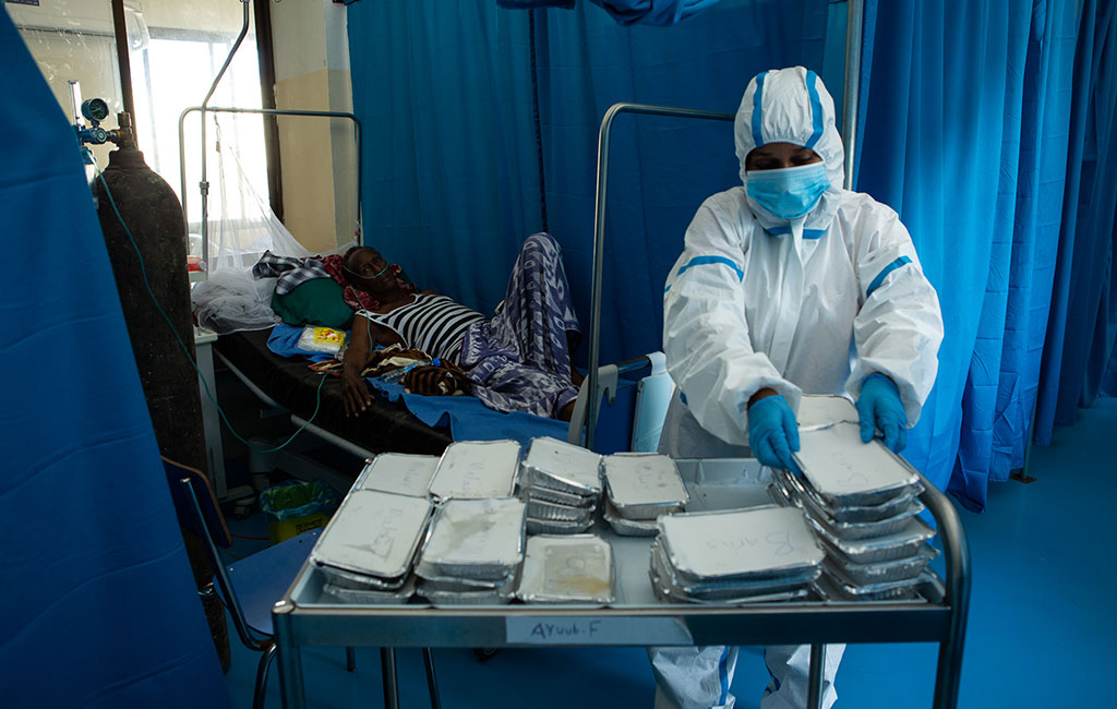 Action Against Hunger staff member delivers food at coronavirus quarantine hospital in Mogadishu, Somalia.