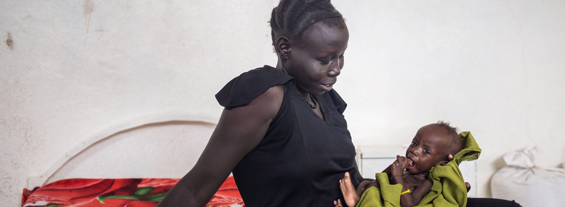 Nyajepe, a South Sudanese refugee, is happy to see the improvement in her child after they received support from Action Against Hunger.