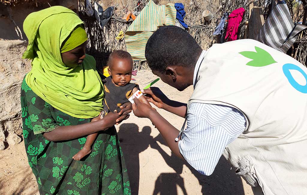 Suldana is screened for malnutrition by an Action Against Hunger staff member in Somalia.