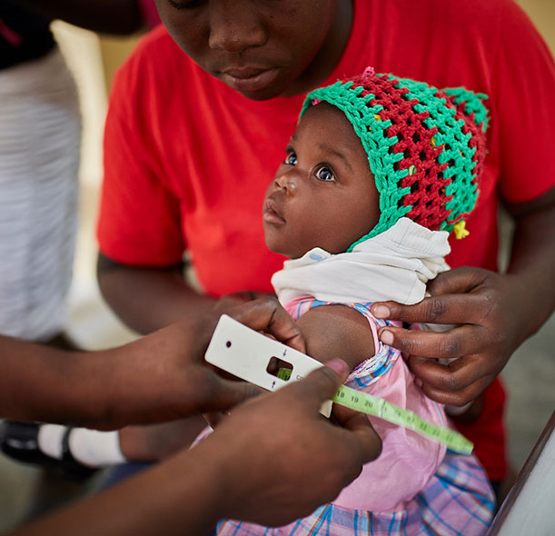 A child is screened for malnutrition using a MUAC band at an Action Against Hunger treatment centre in Haiti.