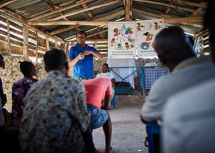 Action Against Hunger staff member Trazilio gives a hygiene lesson in Haiti.