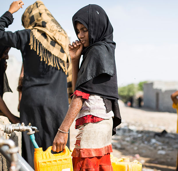 A girl collecting water in Yemen.