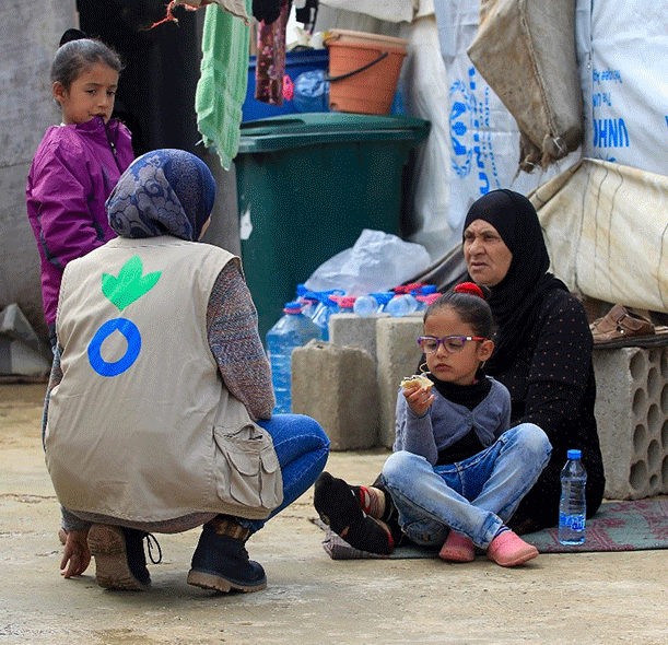 Action Against Hunger staff with Syrian family