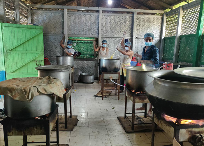 Action Against Hunger staff members at community kitchen help communities affected by the fires at a Rohingya refugee camp in Cox's Bazar, Bangladesh.