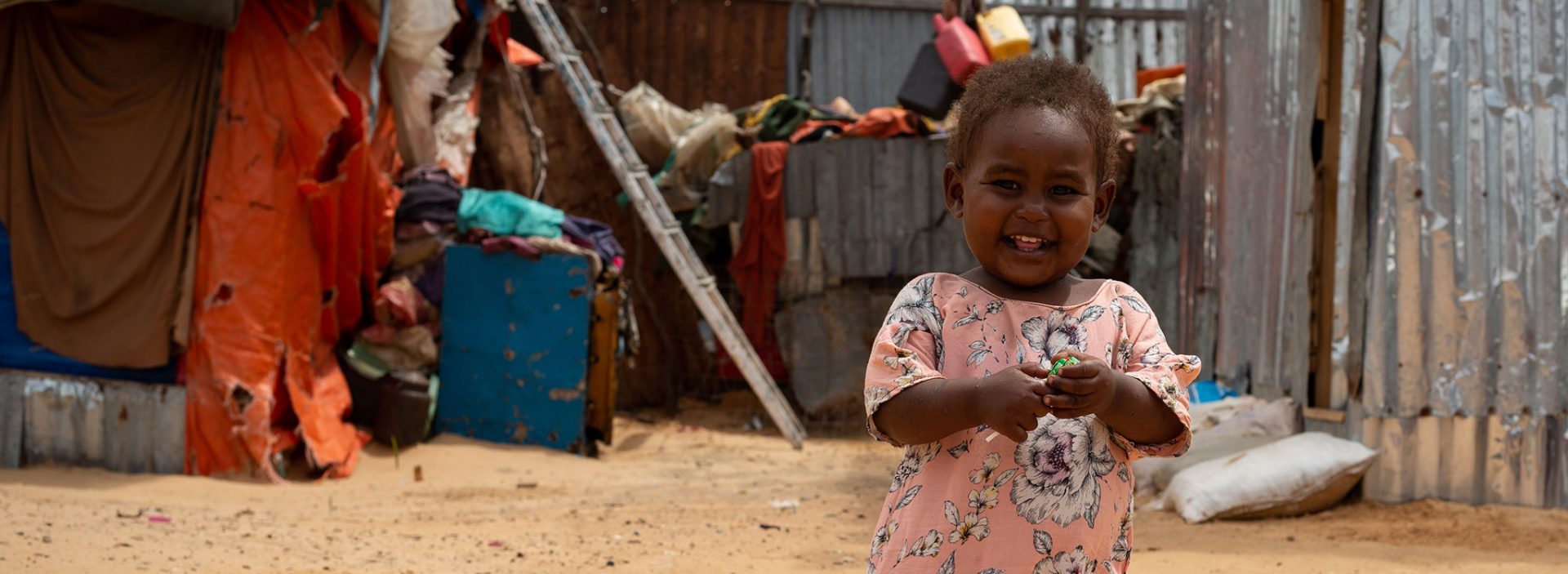 Halima walks around her home in an internally displaced people camp in Somalia. Halima recovered from life-threatening malnutrition thanks to the support of Action Against Hunger.