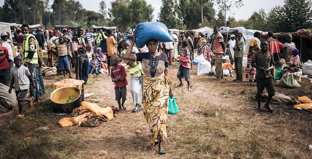 A woman collects food at a fair organised by Action Against Hunger in Democratic Republic of Congo.