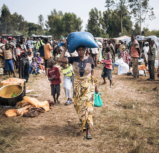 A woman collects food at a fair organised by Action Against Hunger in Democratic Republic of Congo.