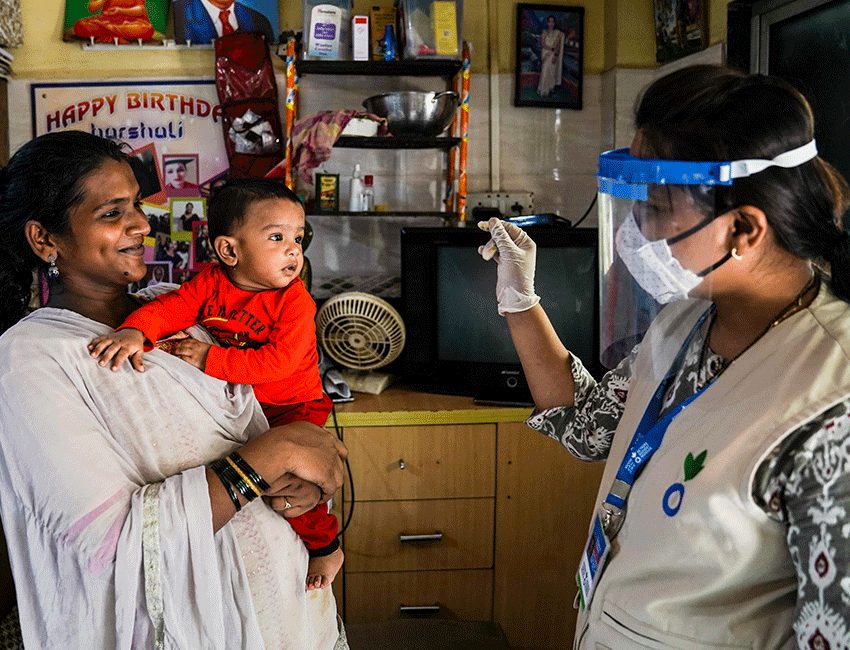 Woman and her baby being visited by an Action Against Hunger community mobiliser in India