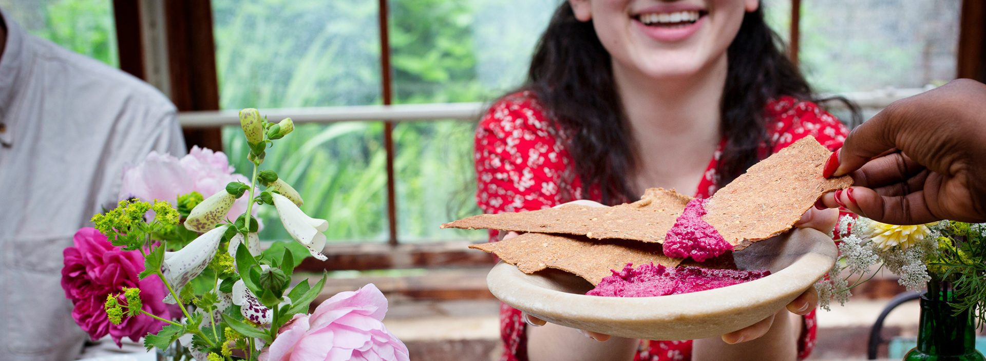 A person dips a tortilla chip into some dip. Sign up to this year's Love Food Give Food campaign.