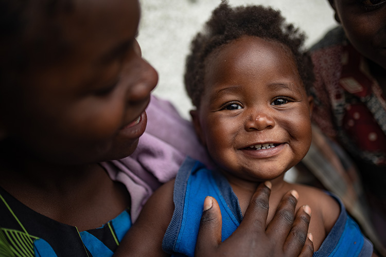 A picture of a smiling girl called Olivine. She's been supported by Action Against Hunger's projects in the Democratic Republic of Congo.