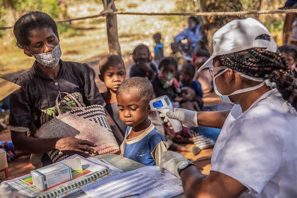 A boy's temperate is checked at an Action Against Hunger project in Madagascar.