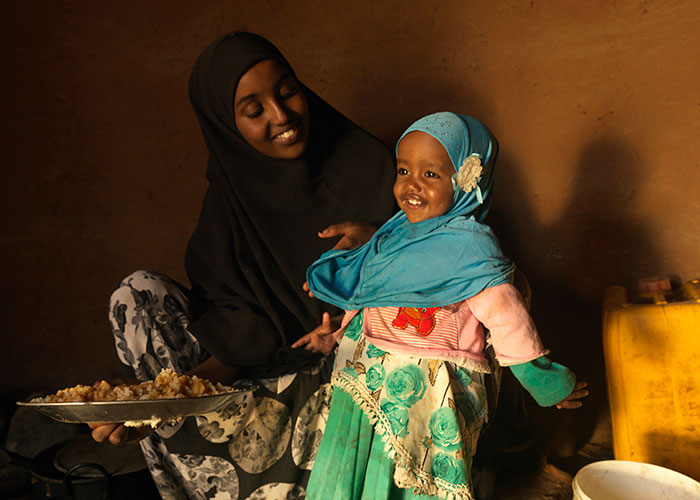 Medina and her daughter Munira enjoy a meal at their home in Ethiopia.