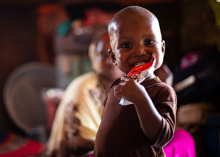 Mohamed eats ready-to-use therapeutic food at an Action Against Hunger stabilisation centre in Mogadishu, Somalia.