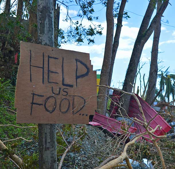 Typhoon Rai has caused widespread destruction in the Philippines. A sign on the side of a highway says 