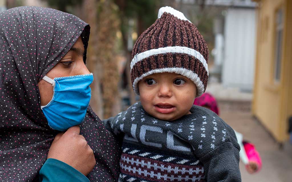 A boy with his mother outside a hospital in northwest Afghanistan.