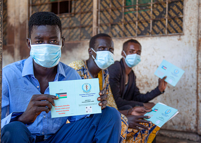 People in South Sudan show their proof of vaccination cards