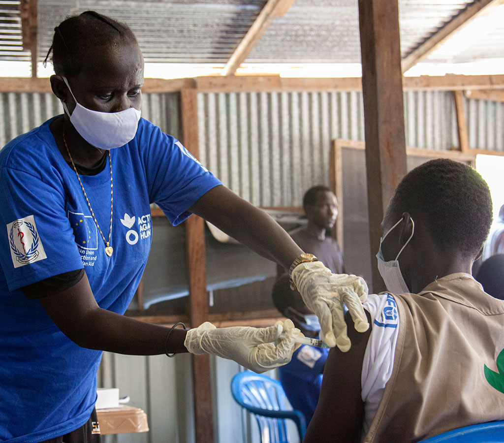 Action Against Hunger staff member administers the vaccine to her colleague in South Sudan