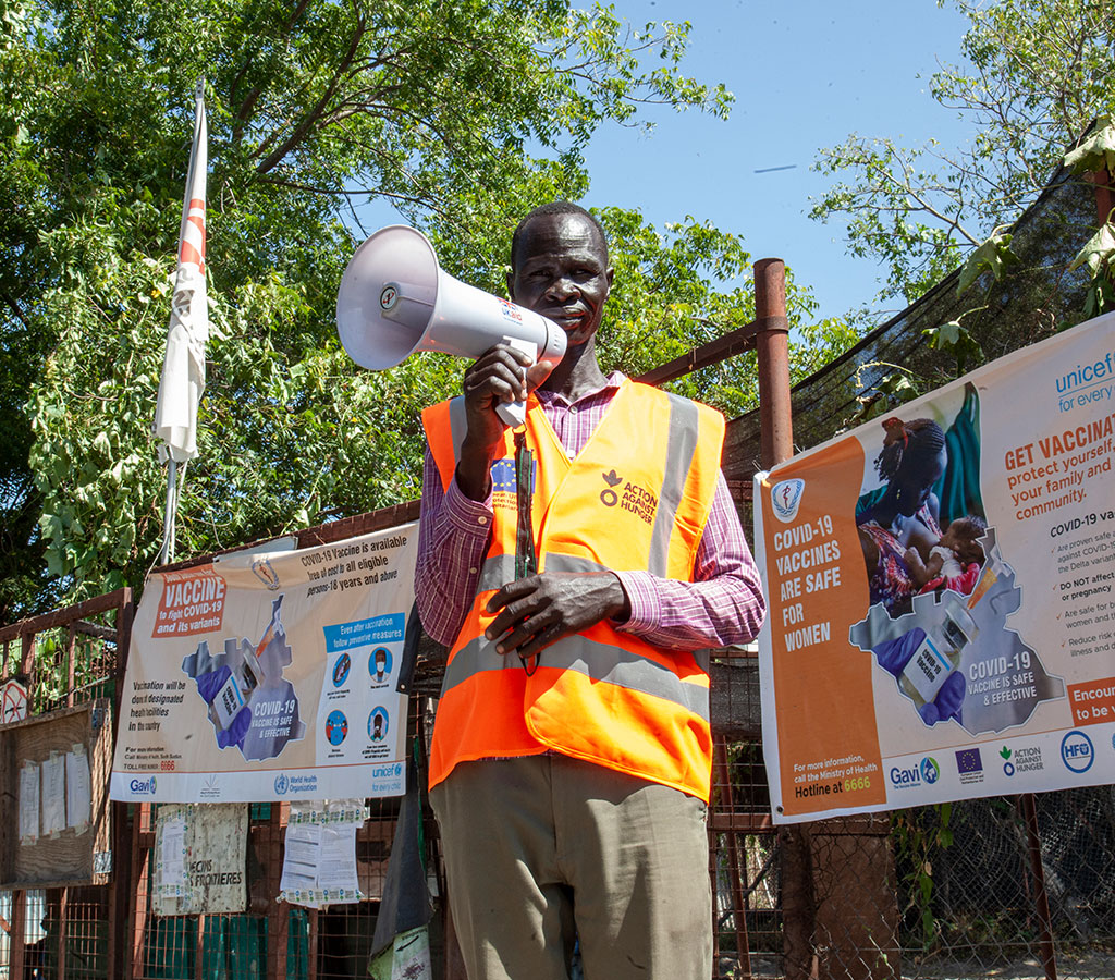 A social mobiliser, Gatluok Riemkhor standing outside the hospital gate urging for people to accept and take the vaccine in old Fangak, South Sudan