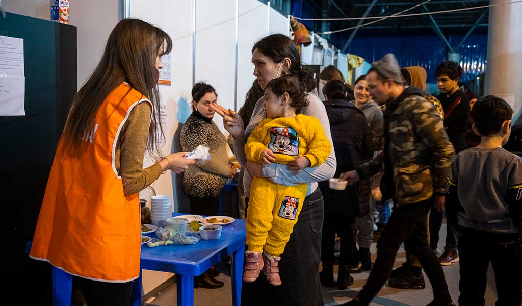 A woman asks for help at the Moldexpo exhibition centre, currently being used to shelter Ukranian refugees.