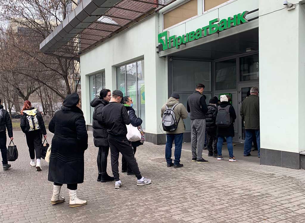 Queues at banks while people try to withdraw cash.