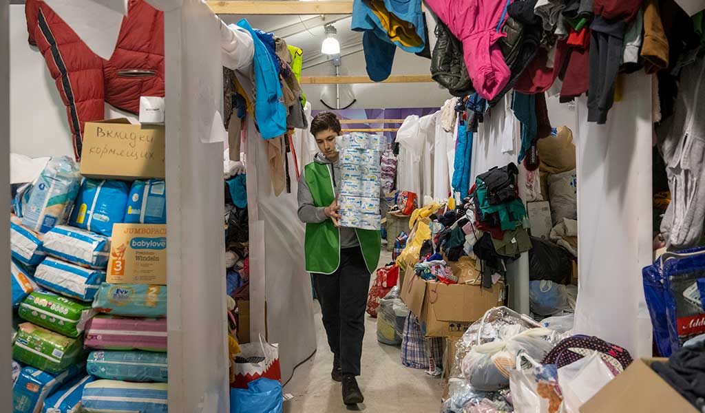 A volunteer with supplies at the Moldexpo exhibition centre, currently being used to shelter Ukrainian refugees.