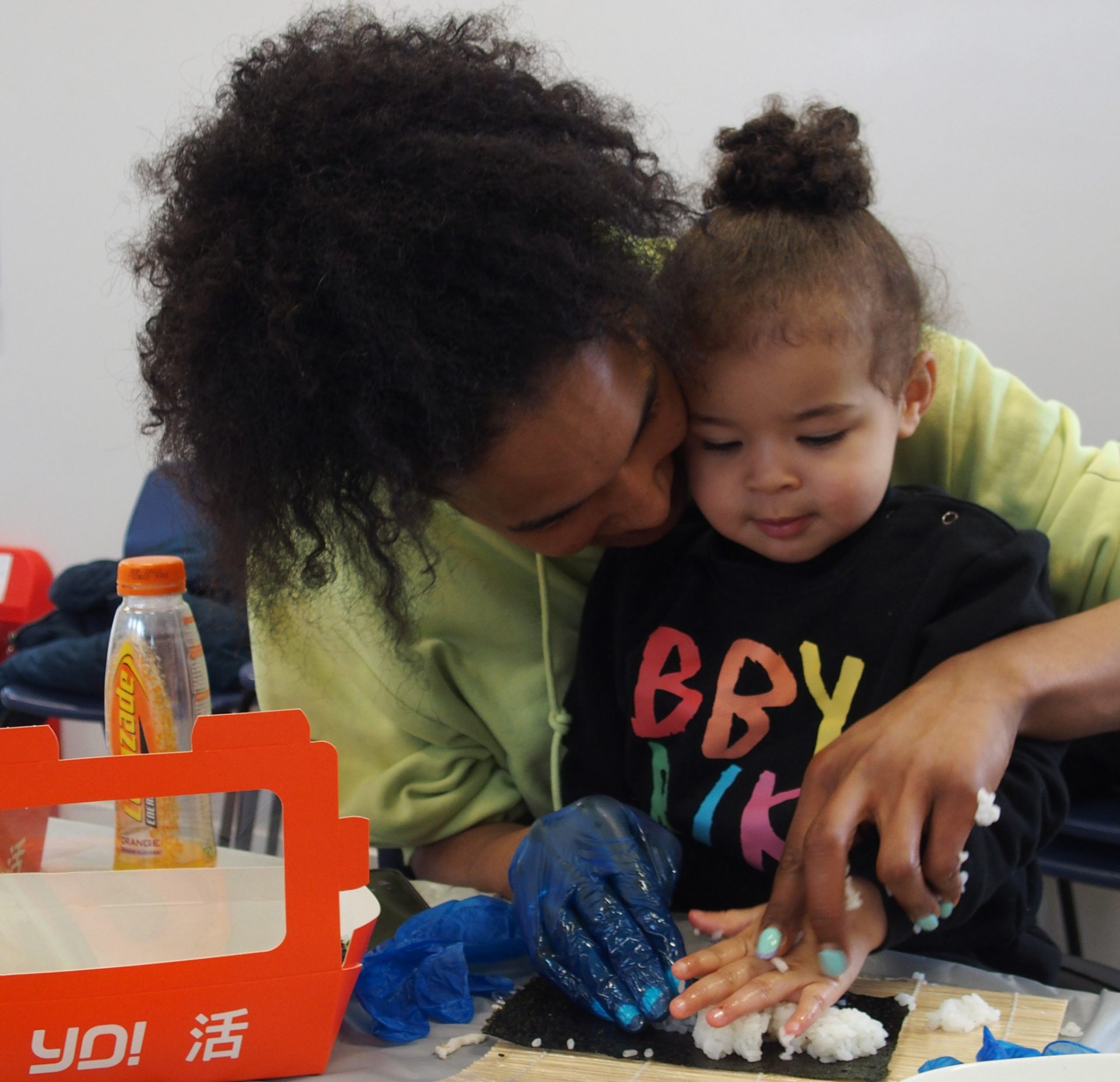 Mother and young child making sushi at class at Brasshouse Community Centre, Smethwick