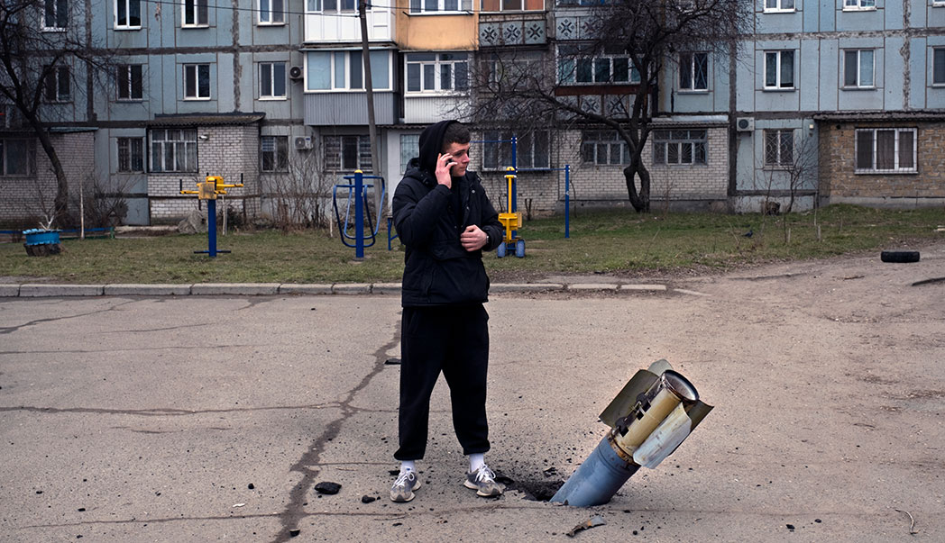 A man stands next to an unexploded missile in Mykolaiv, Ukraine.