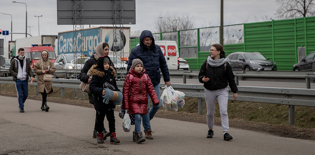 Ukrainian refugees cross the border into Dolhobyczow, Poland.