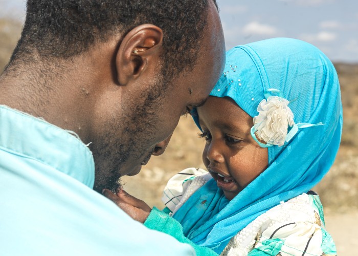 Munira and her father after Action Against Hunger had treated her for malnutrition using therapeutic nutritious food supplements