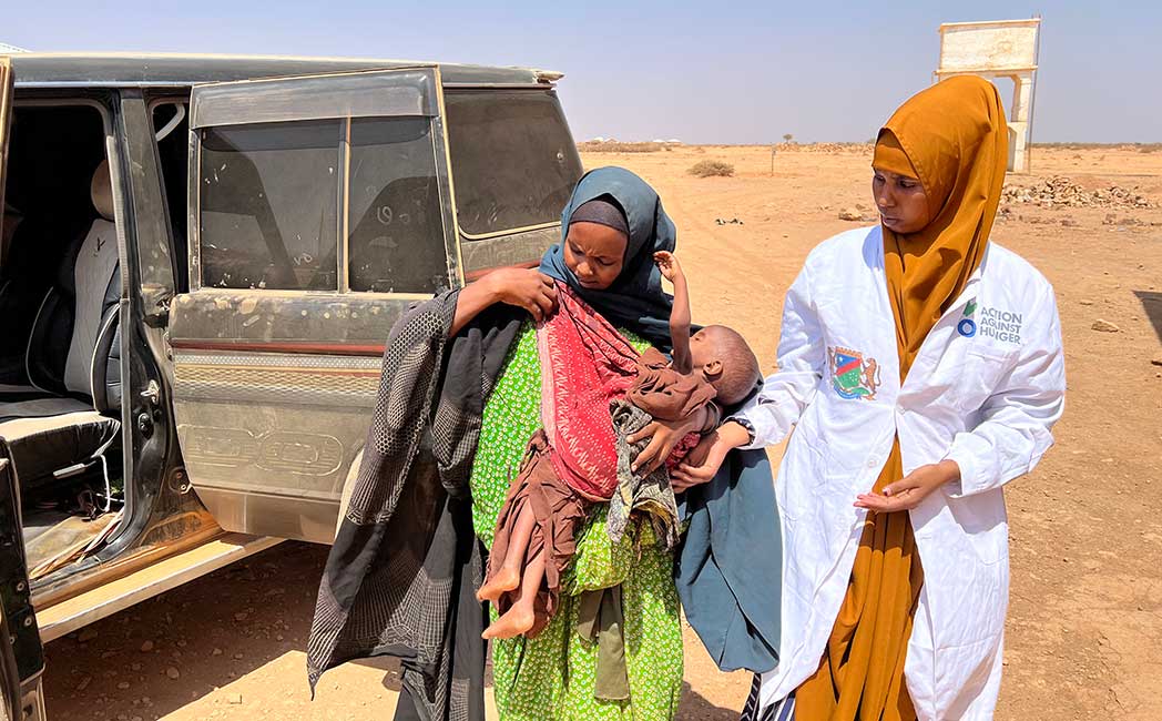 A mobile health worker from Action Against Hunger takes Aftin and her malnourished child to a stabilisation centre for treatment.