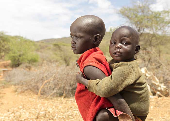 Chepangat, a little girl from Kenya who our teams saved from severe malnutrition in Kenya, with her sister Chepoisho.