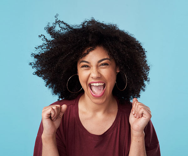 Woman with frizzy hair celebrates winning the lottery.