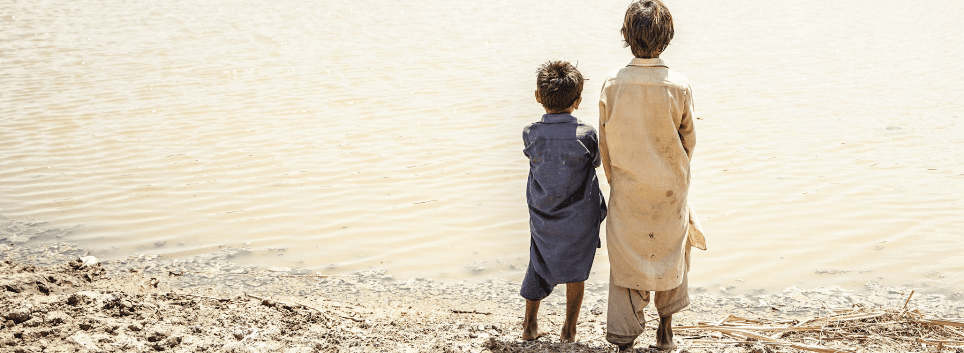 Two boys looks out onto the destruction caused by floods in Pakistan.