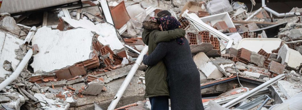 Two people hug in the rubble after two devastating earthquakes hit Turkey and Syria.