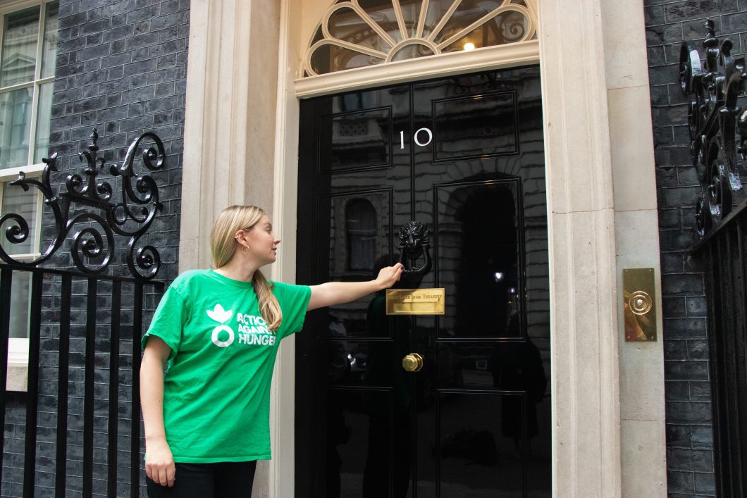 Advocacy campaigns manager, Anna, knocking on the door of 10 Downing Street