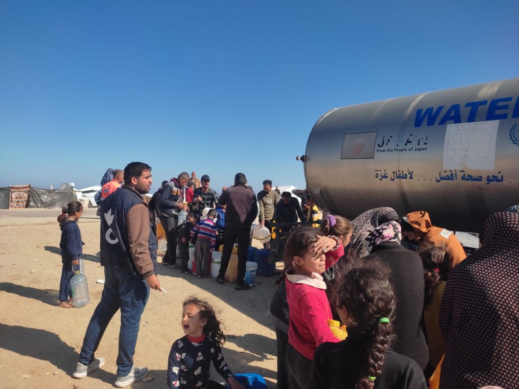 Action Against Hunger aid workers unloading aid truck in Gaza.
