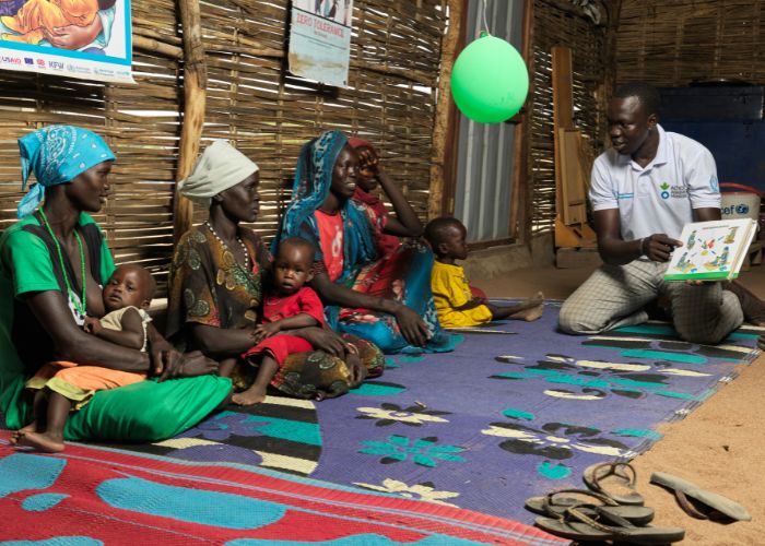 Sudanese women and their babies receiving malnutrition support from Action Against Hunger.