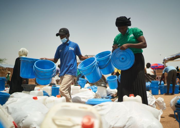 Action Against Hunger team delivering clean water aid to Sudanese refugees.