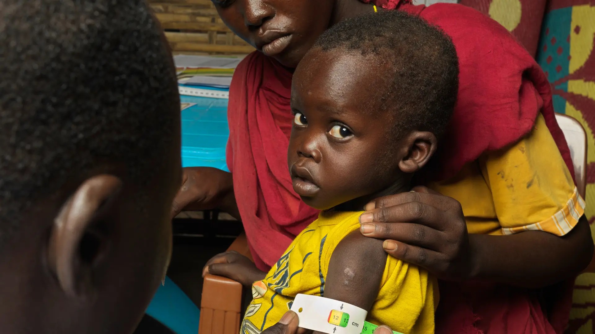 Child in Sudan conflict with his mother.