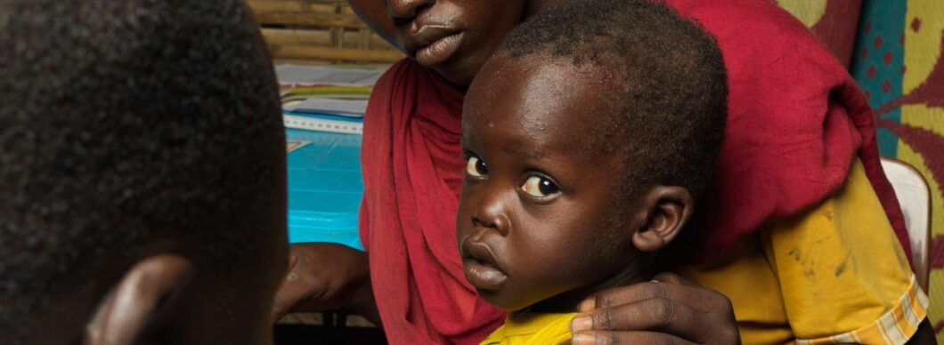 Child in Sudan conflict with his mother.